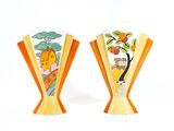 two vases that have been painted with oranges on them