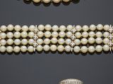 a group of three pearl and diamond bracelets and a broochet