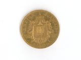 an old gold coin on a white surface with a white background