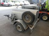 a truck with a trailer attached to it in a garage