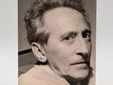 an old black and white photo of a man with a pipe in his mouth