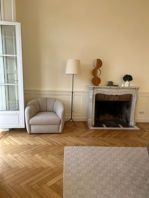 a living room with two chairs and a fireplace