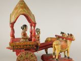 figurine représentant une calèche tirée par des chevaux, avec un homme à bord