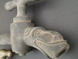 a faucet that is attached to a wall with a faucet attached to it