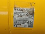 the back of a yellow machine with a sticker on it ' s side