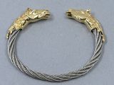 a close up of a bracelet with two horses on it