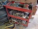 a red cart filled with tools on a tiled floor