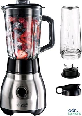 a blender that is sitting next to a glass of water
