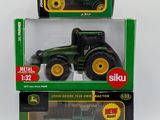 two green and yellow toy tractors in a box