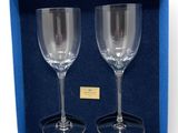 two empty wine glasses in a blue gift box on a white background