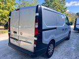 the back of a silver van parked in a parking lot