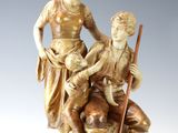 an image of a statue of a man and a woman sitting on a rock