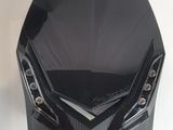 the front of a black motorcycle with a helmet on it ' s head