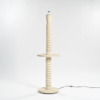 a white floor lamp with a wooden base and a black cord