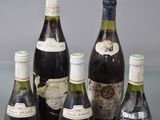 several bottles of wine are lined up on a table