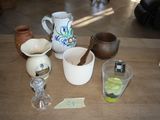 a wooden table topped with cups and bowls on it