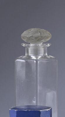 a small glass bottle with a lid on a table