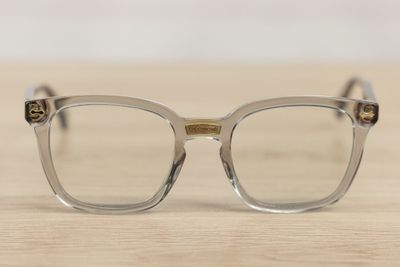 a pair of glasses sitting on a wooden table