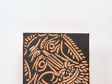 a wooden block with an image of a bird on it