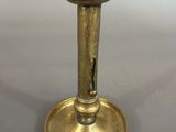 a gold plated candle holder on a white background