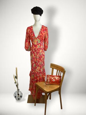 an image of a mannequin with a red dress and a wooden chair