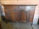 a very old wooden cabinet in the corner of the room