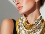 the woman is wearing a black top and a yellow scarf