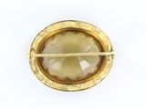 a close up of a brooch with chopsticks in it