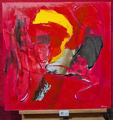une peinture représentant une œuvre abstraite rouge et jaune posée sur un chevalet en bois