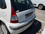 a small white car parked in a parking lot