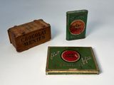 two tins of chocolate sitting next to a box of chocolate