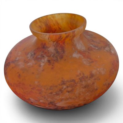 a large orange vase sitting on a white surface