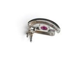 a silver ring with a pink eye on it