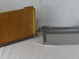 two pieces of wood and metal on a table