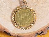 a gold coin is sitting on top of a piece of wood