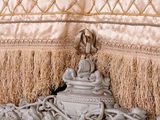 a close up of a bed with a pillow and pillows