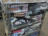 a metal cart with many items in it in a warehouse