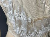 a close up of a mannequin with a white dress on it