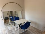 a table with chairs and a mirror in a room