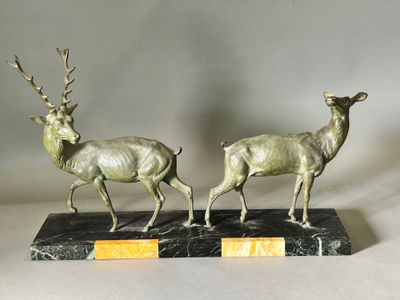 pair of bronze deer sculptures on marble base