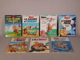 plusieurs livres pour enfants sont alignés sur une surface blanche