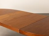 the table is made of wood and has a curved top