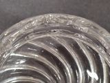 a clear glass bowl with a spiral design on it