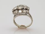 a close up of a diamond ring on a white surface