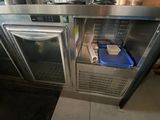a stainless steel counter with a blue container on top of it