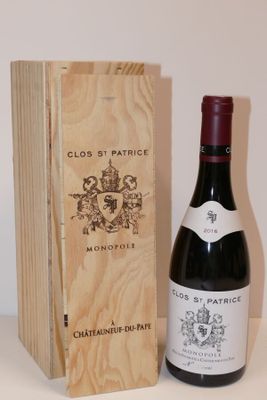 a bottle of wine sitting next to a wooden box