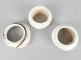 three white vases sitting on top of a table next to each other