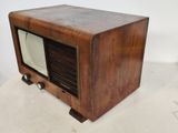 an old fashioned television sitting on a white surface