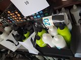 many bottles of water sitting in a box on a table