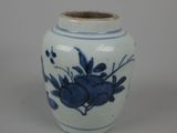 a blue and white vase with flowers on it